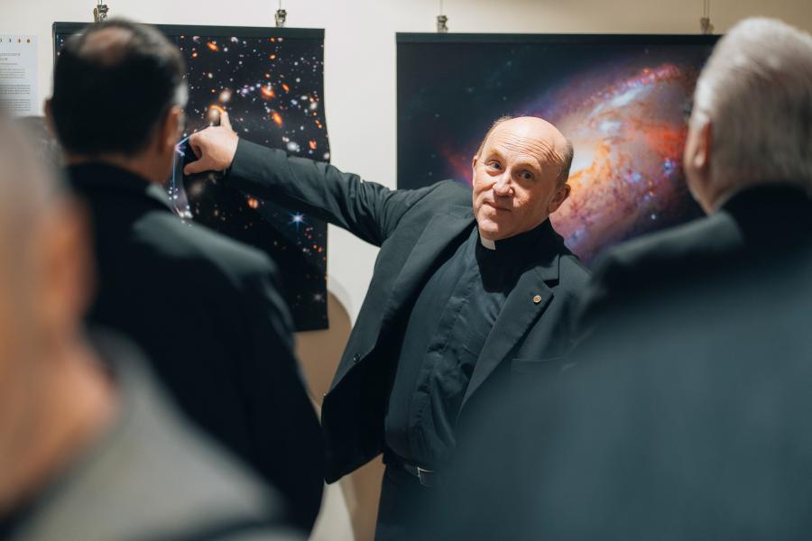 A man points to an image of the stars
