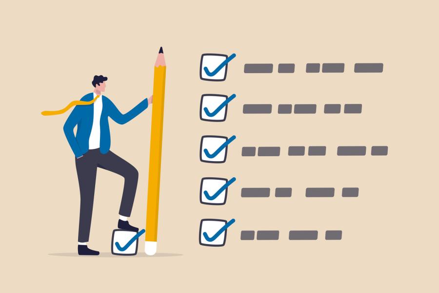 Man standing with tall pencil next to a to-do list that has everything checked off