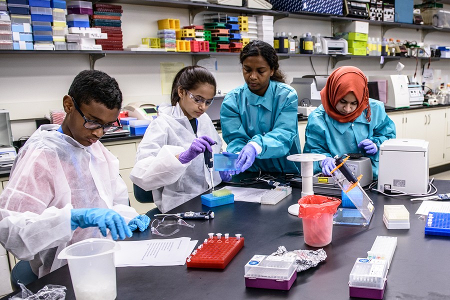 Seventgh-graders use pipettes and other tools in the Johns Hopkins Wet Lab