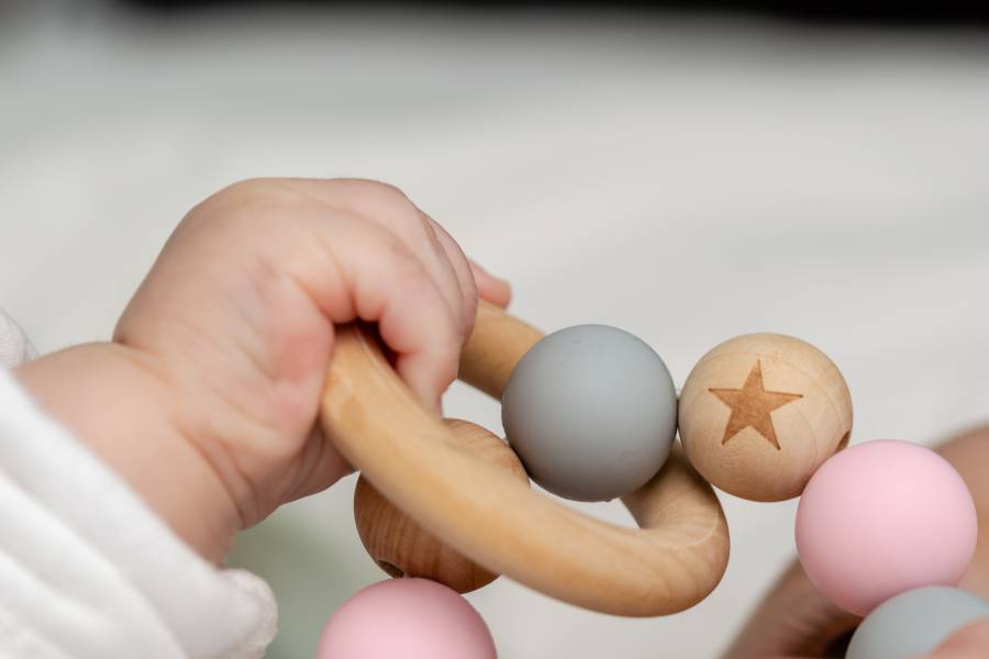 A child's hand holds a toy