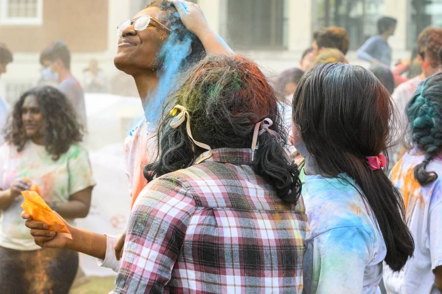 Students throw powdered dye at each other 