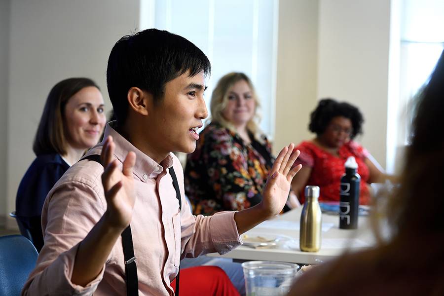 A student speaks at a workshop 