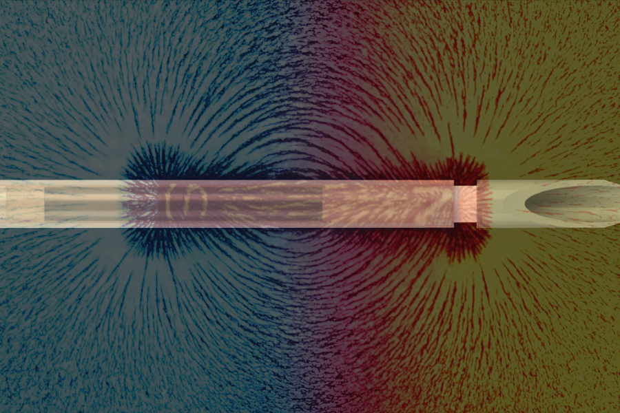 Image of a magnet attracting metal shavings with a needle superimposed over the image