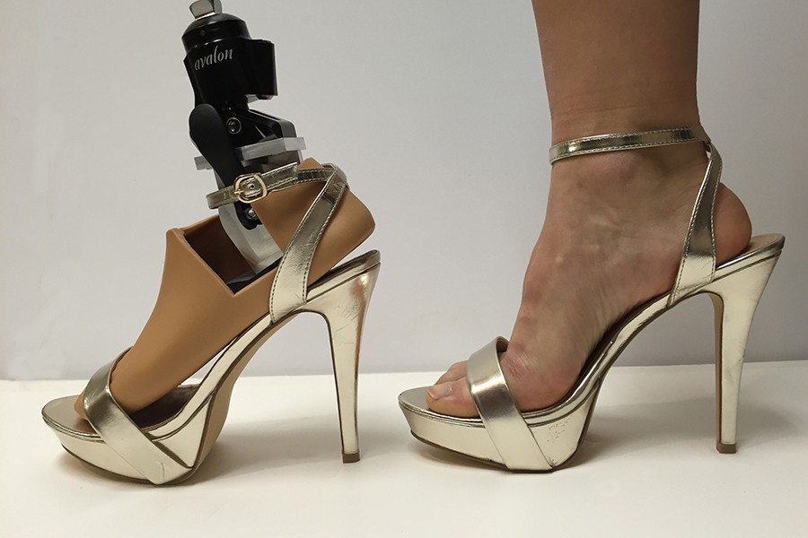 A prosthetic foot in a gold platform stiletto 