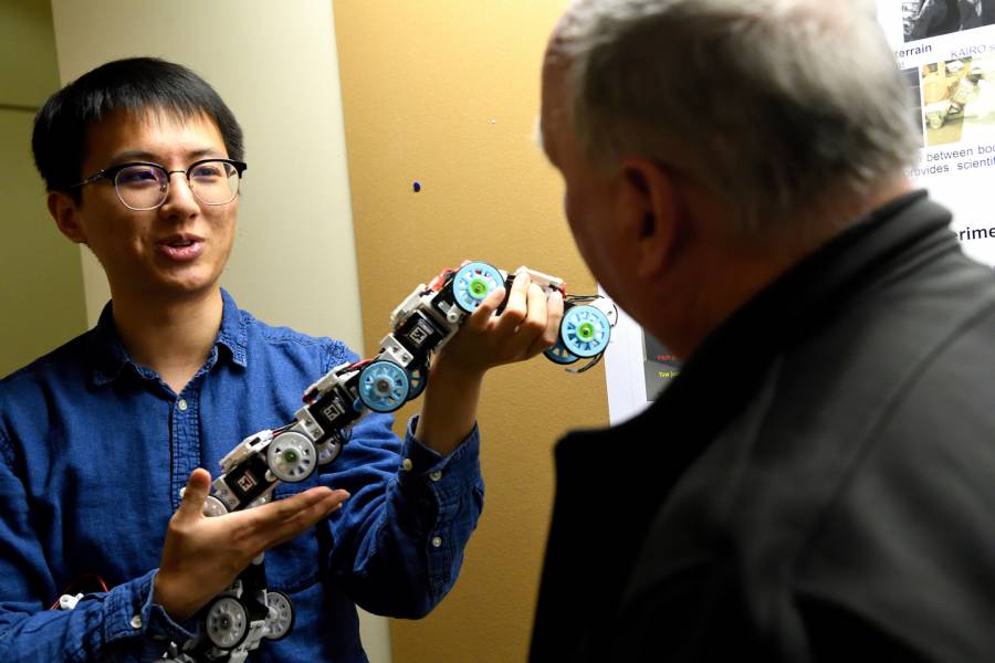 A student demonstrates a robotics project