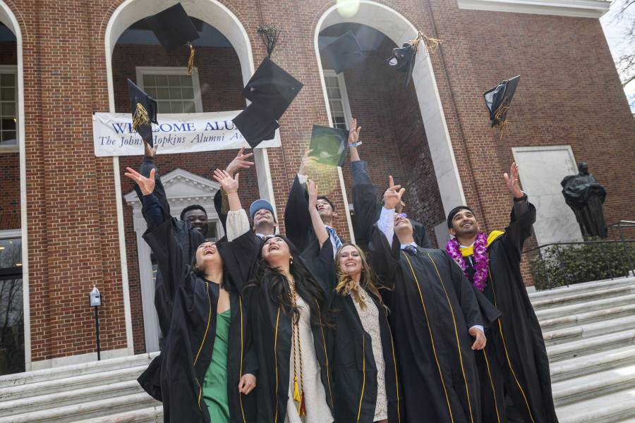 2020 graduates toss their caps