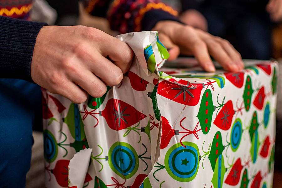 Man’s hands unwrapping a gift