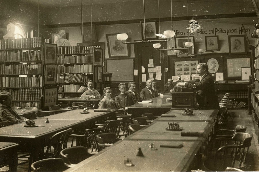 A group of men sit in a seminar room