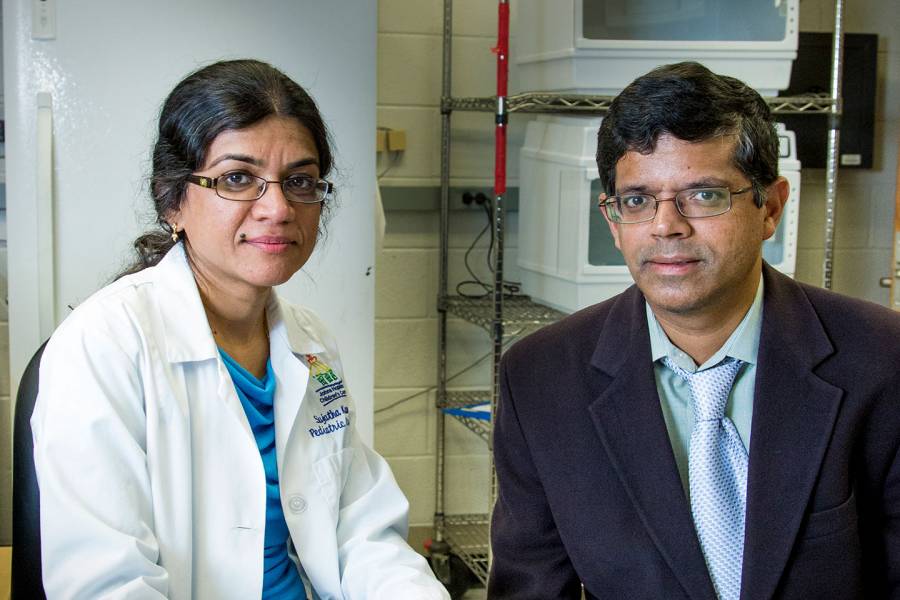 Johns Hopkins researchers Sujatha Kannan and Kannan Rangaramanujam sitting in a lab
