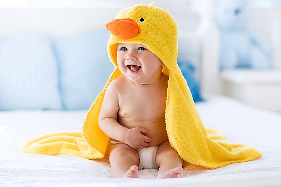 Infant with bright yellow towel