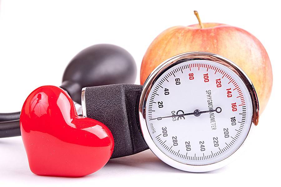 Blood pressure gauge, apple, and shiny red heart