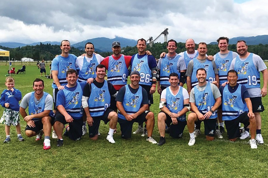 A group photo of lacrosse players in their 30s and 40s