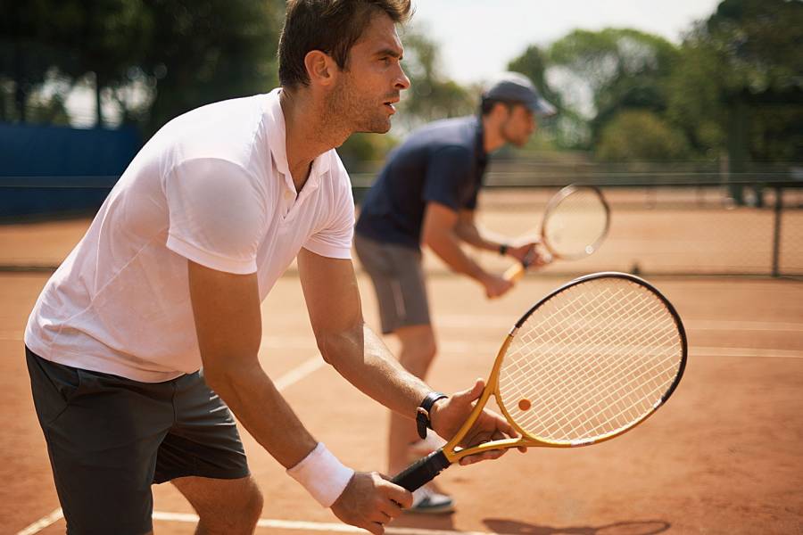 Two men playing tennis