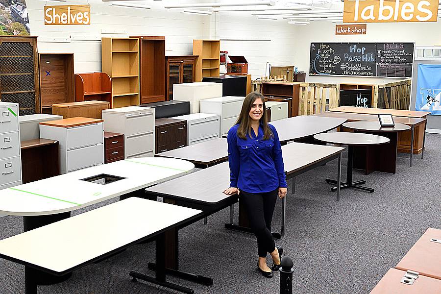 Brigid Gregory in the Hop Reuse Hub, surrounded by tables, file cabinets, and bookcases