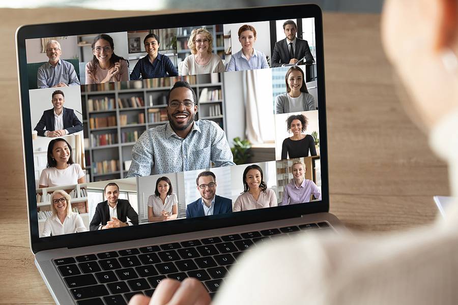 Laptop showing group of engaged employees in a Zoom meeting