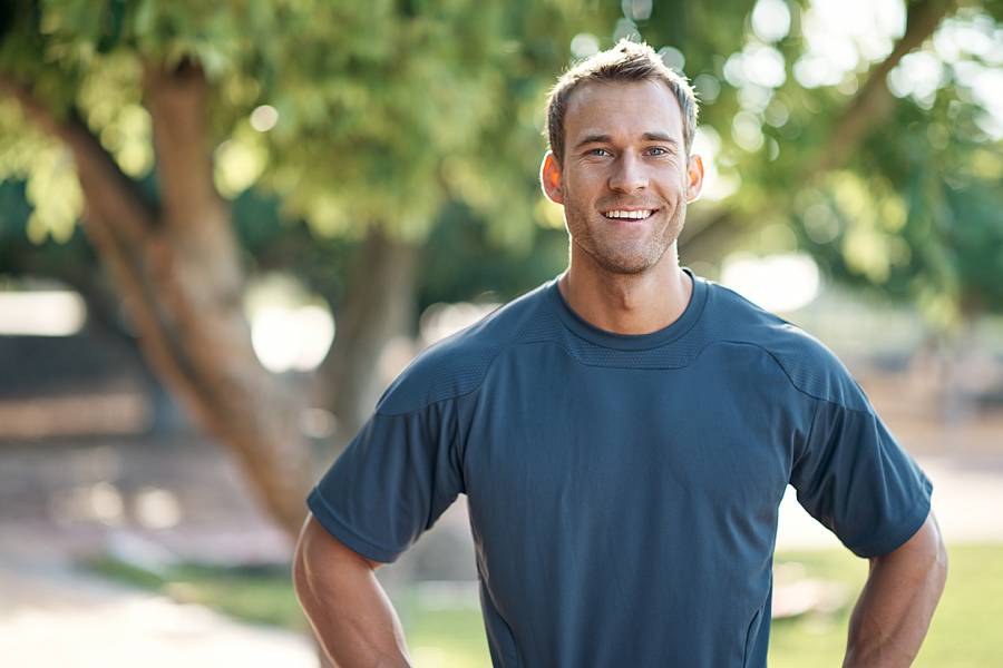 Healthy-looking smiling man photographed outdoors
