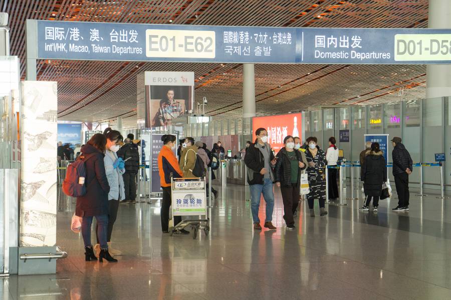 People wearing masks in an airport in Beijing