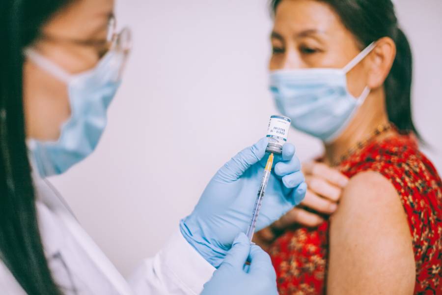 A nurse administers a COVID-19 vaccine