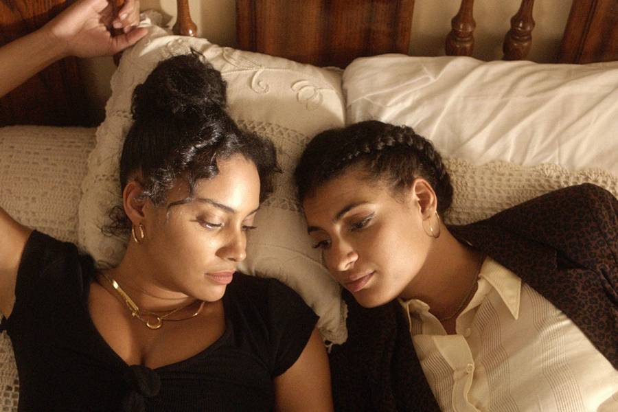 In this scene from De Lo Mio, two sisters lay on their grandfather's bed