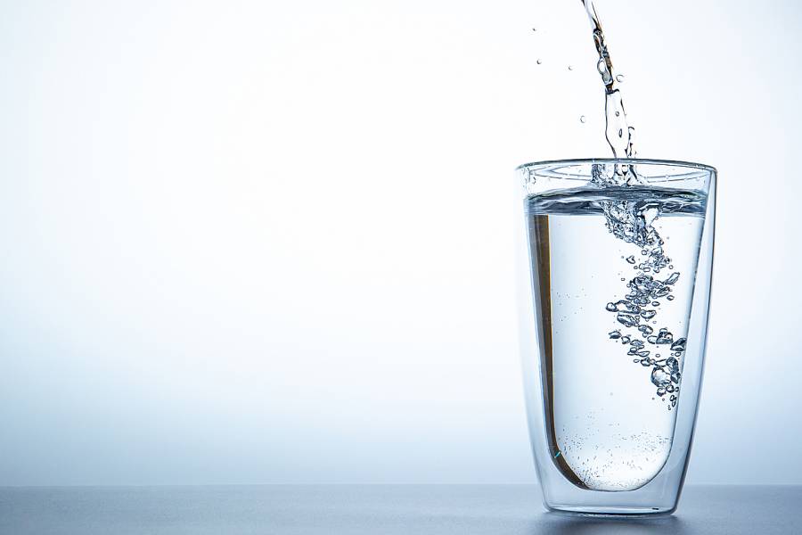 Water being poured into a large tumbler