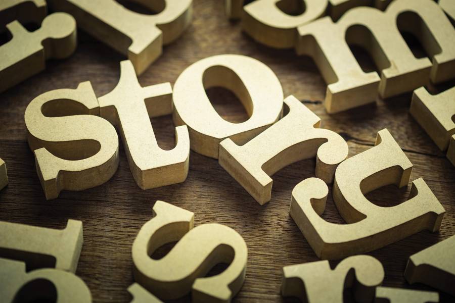 gold block letters spell out the word "story"