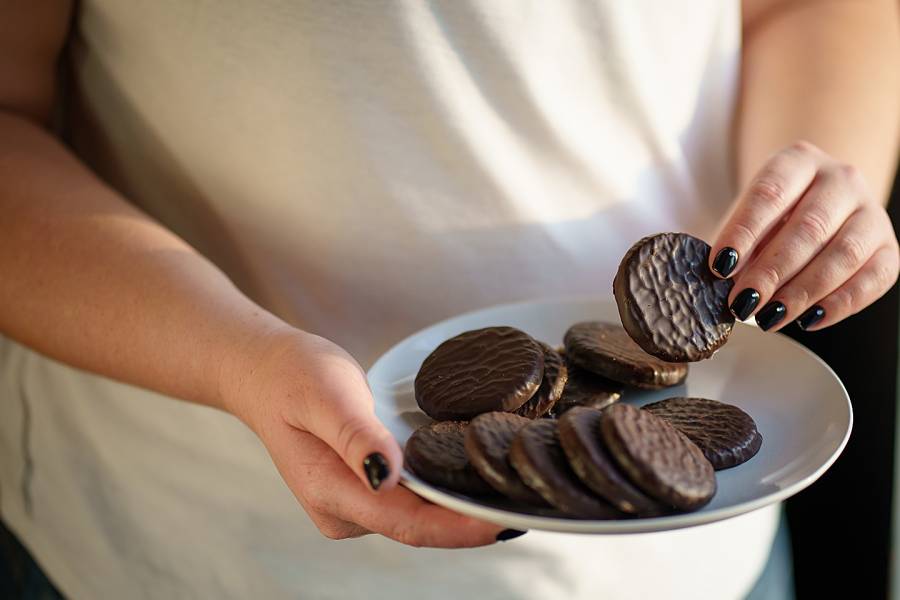 Woman's hand holding plate of cookies