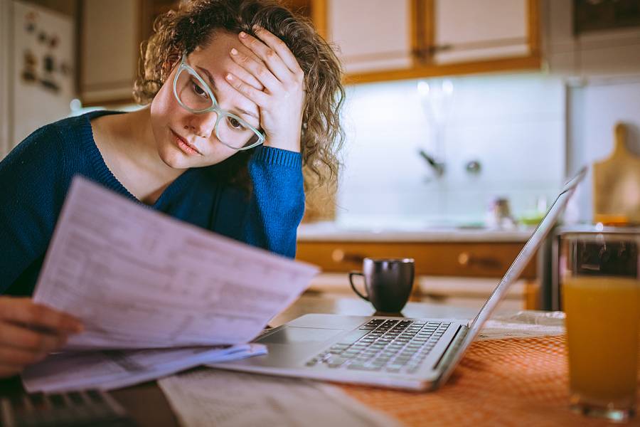 Woman appearing upset when looking at financial information