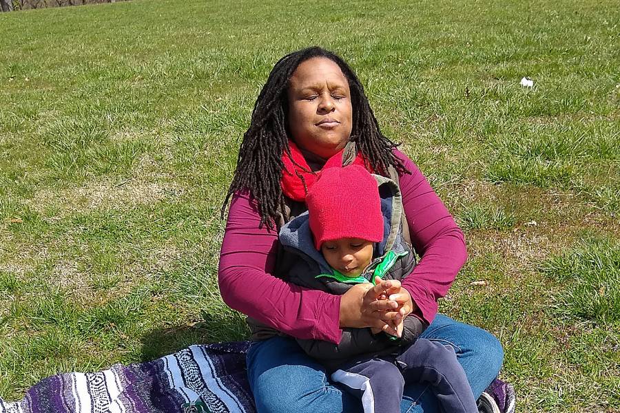 Essence Pierce and her son Joshua relax on the grounds of Lake Montebello near their home in Ednor Gardens.