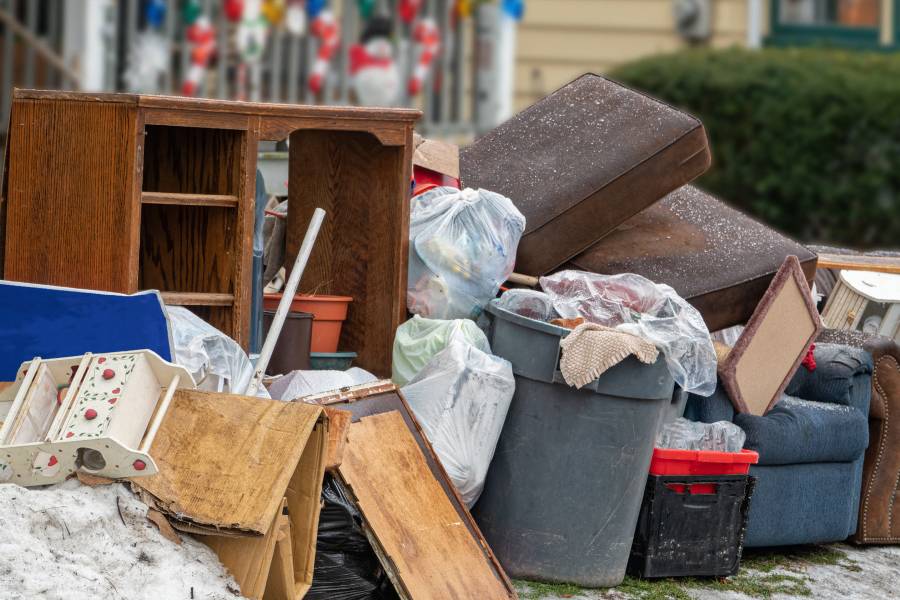 Belongings and debris are piled on the sidewalk after an eviction
