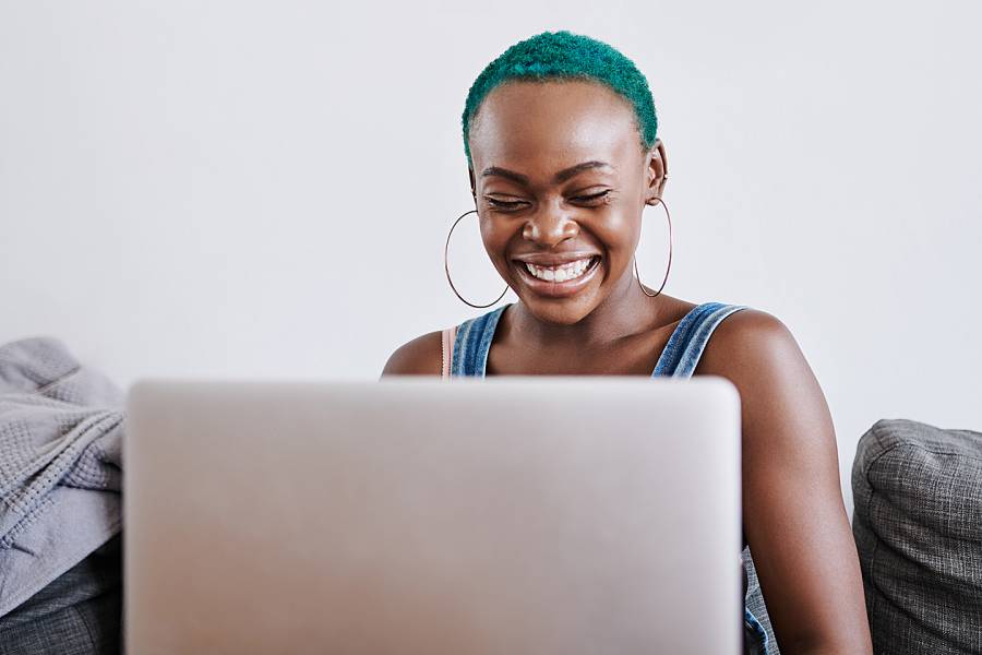 African American woman talking with someone through her computer