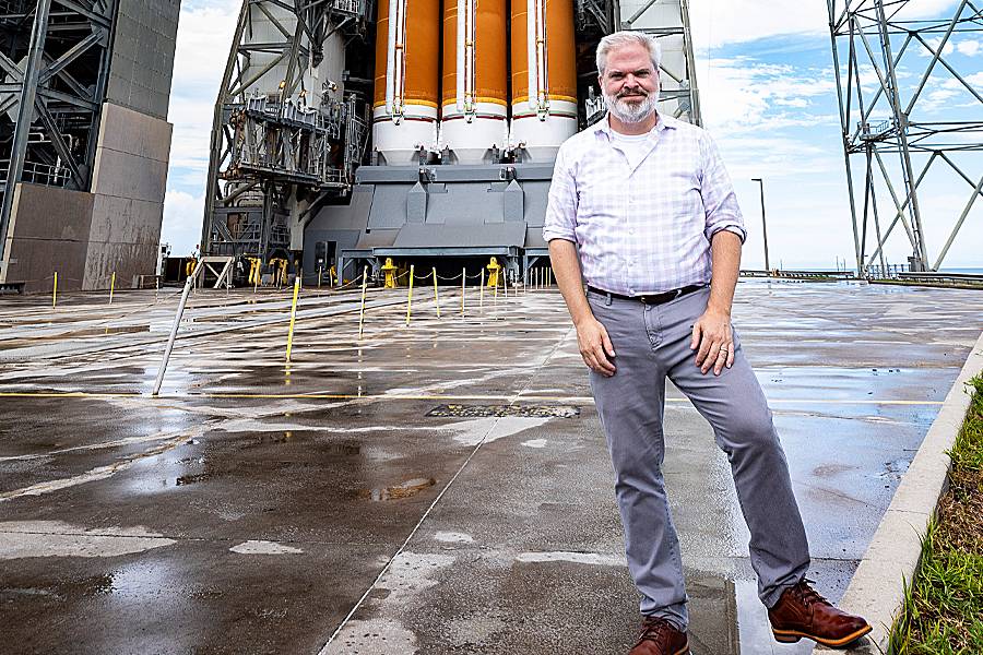Geoff Brown in front of the rocket that would launch the Parker Solar Probe