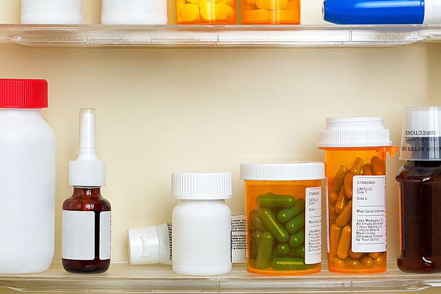 Bottles of prescription drugs on a medicine cabinet shelf