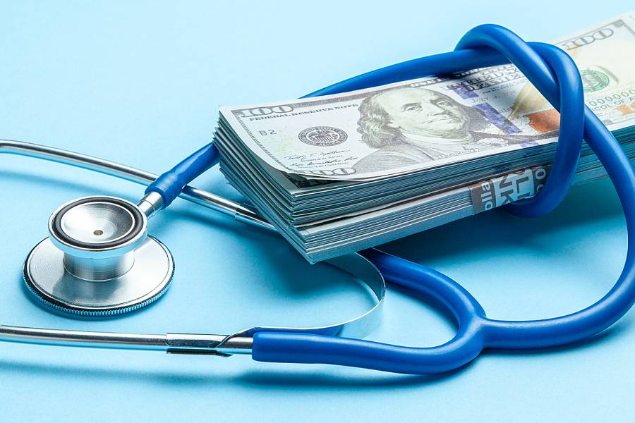 Stethoscope and a stack of money