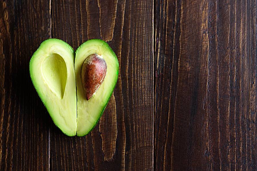Avocado cut in half in shape of a heart