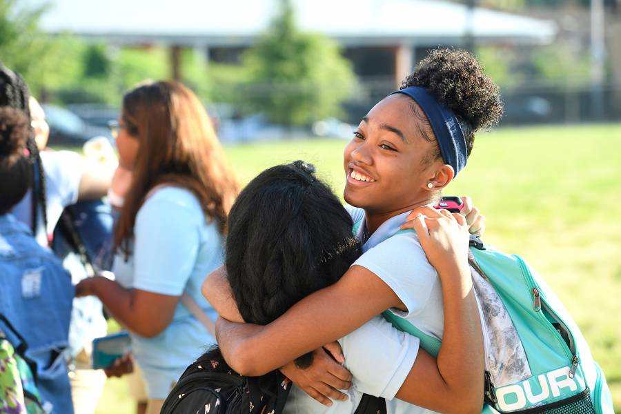 Two students hug on the first day of school