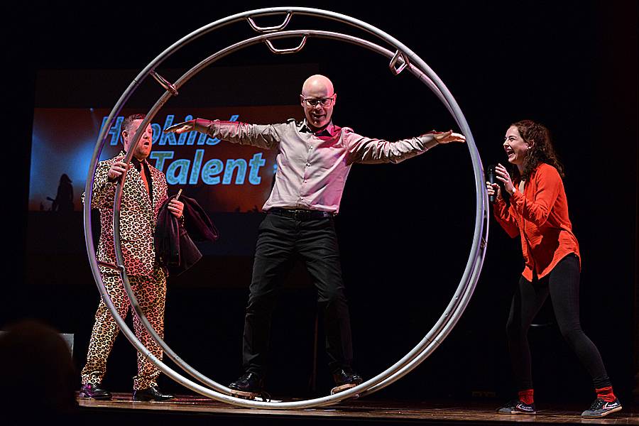 2017 judge Thomas Dolby tries out the gymnast wheel of winner Amanda Gatewood, right, as emcee Ian Reynolds looks on
