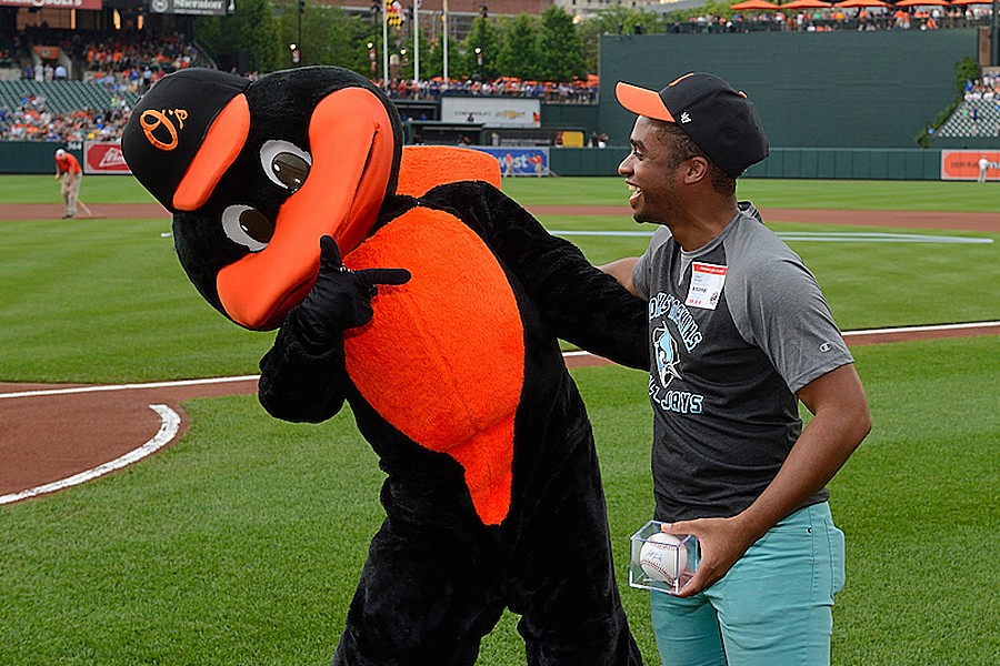 The Orioles mascot welcomes Greg Burks of Johns Hopkins to Hopkins Night at Camden Yards in 2017