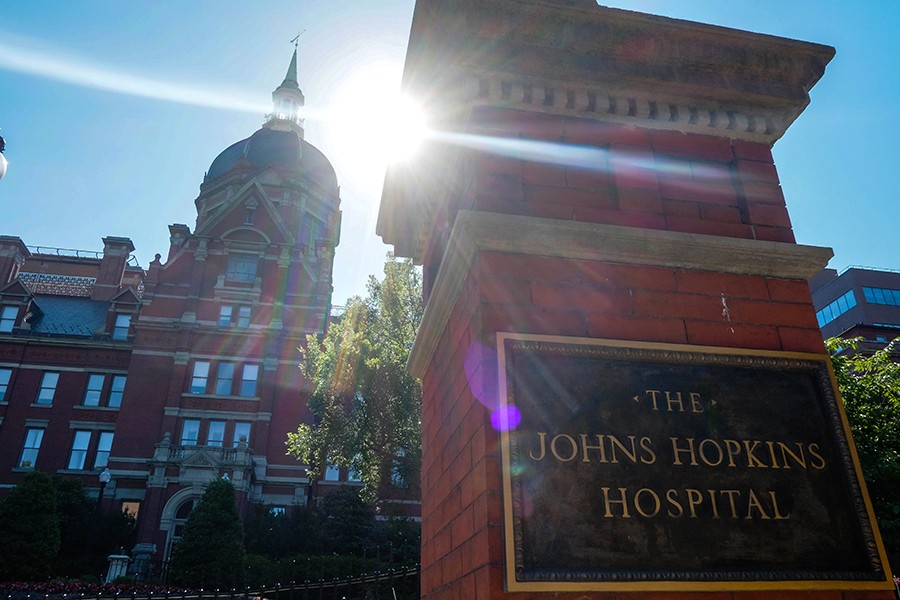 The Johns Hopkins Hospital sign and dome with brightly shining sun