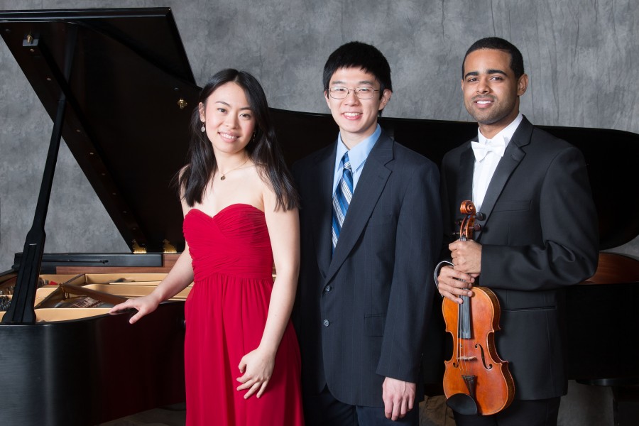 Student soloists Stephanie Cai, Winston Wu, Jordan Elum stand in front of piano