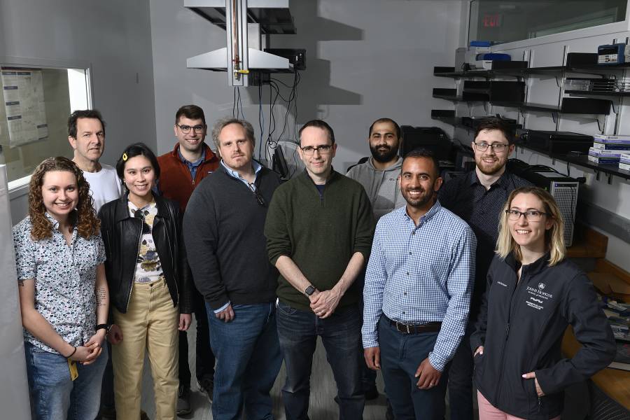 A group photo of the team of Johns Hopkins University team that has collaborated with more than 100 researchers around the world to assemble and analyze the first complete sequence of a human genome