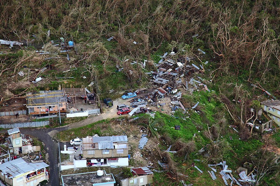 Homes lay in ruin in a rural and wooded area of Puerto Rico