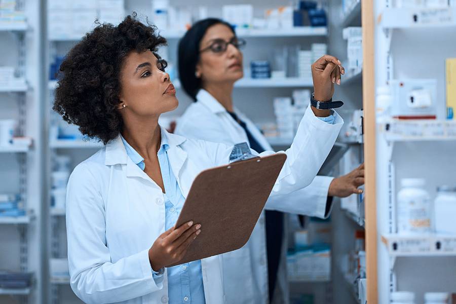 Two female pharmacists looking at their medications