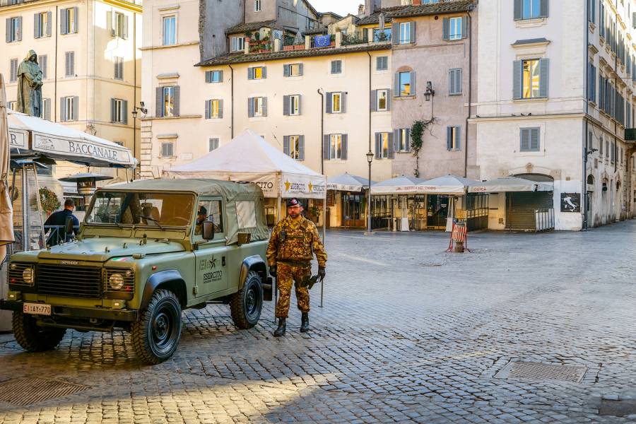 A member of the Italian army guards Piazza Campo de Fiori, which appears almost completely deserted amid the coronavirus outbreak