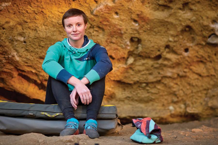 Inventor Jessamy Taylor sits in front of a boulder at Oregon’s Smith Rock State Park 