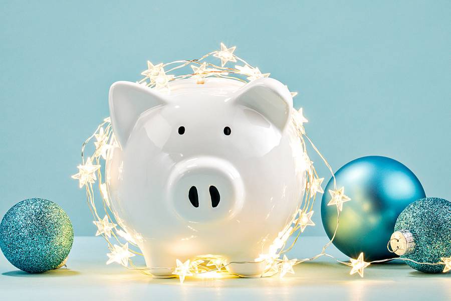 Piggybank decorated with start-shaped lights and Christmas tree balls