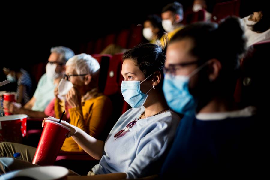 People wearing face masks in a movie theater
