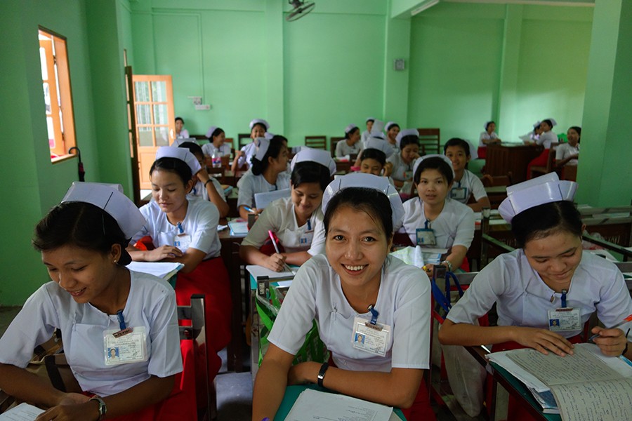 A group of midwives study in a classroom.