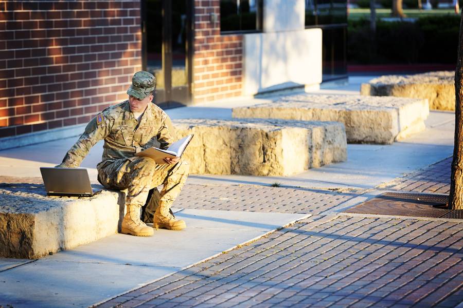 Soldier with laptop and notebook