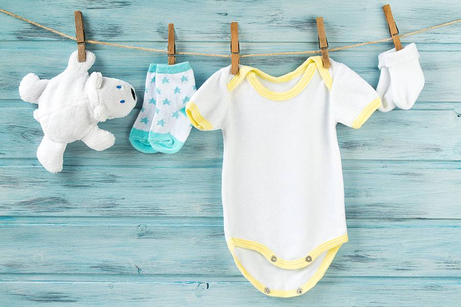 Clothesline holding baby clothes and toy