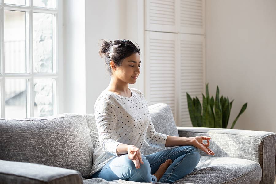 Woman on couch meditating
